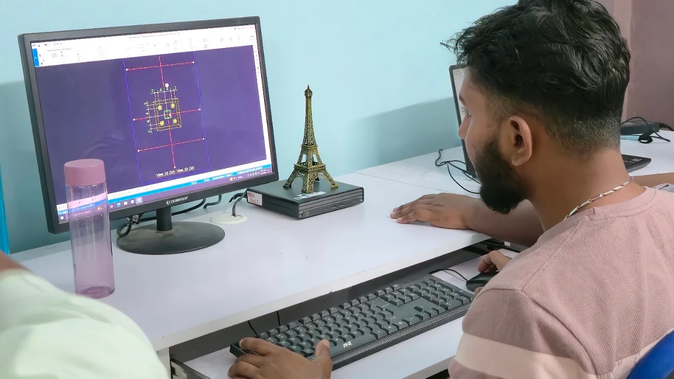 Learner working through a technical drawing during a computer practice session